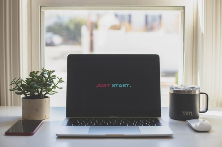 table with computer that says just start