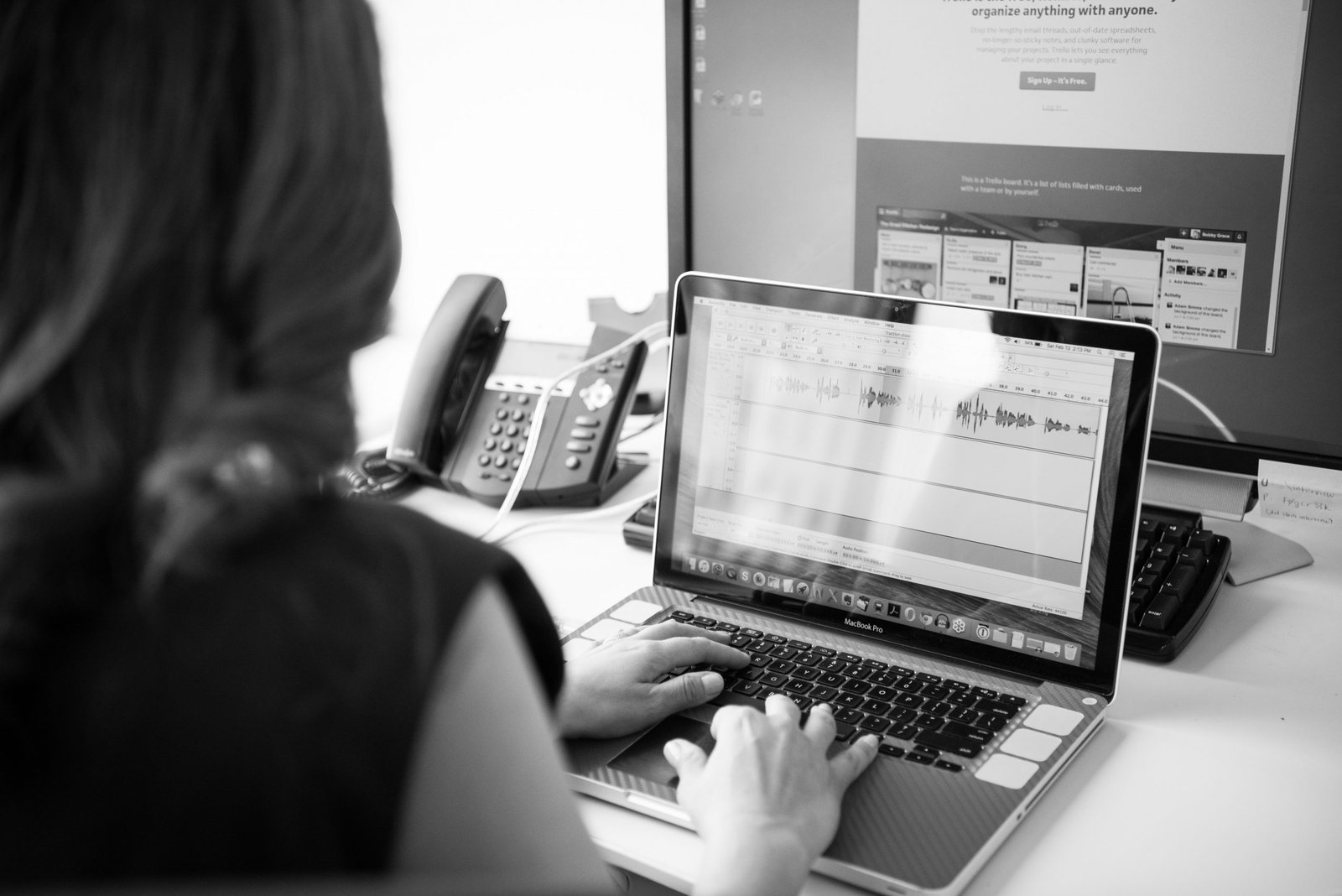 Woman using two computers