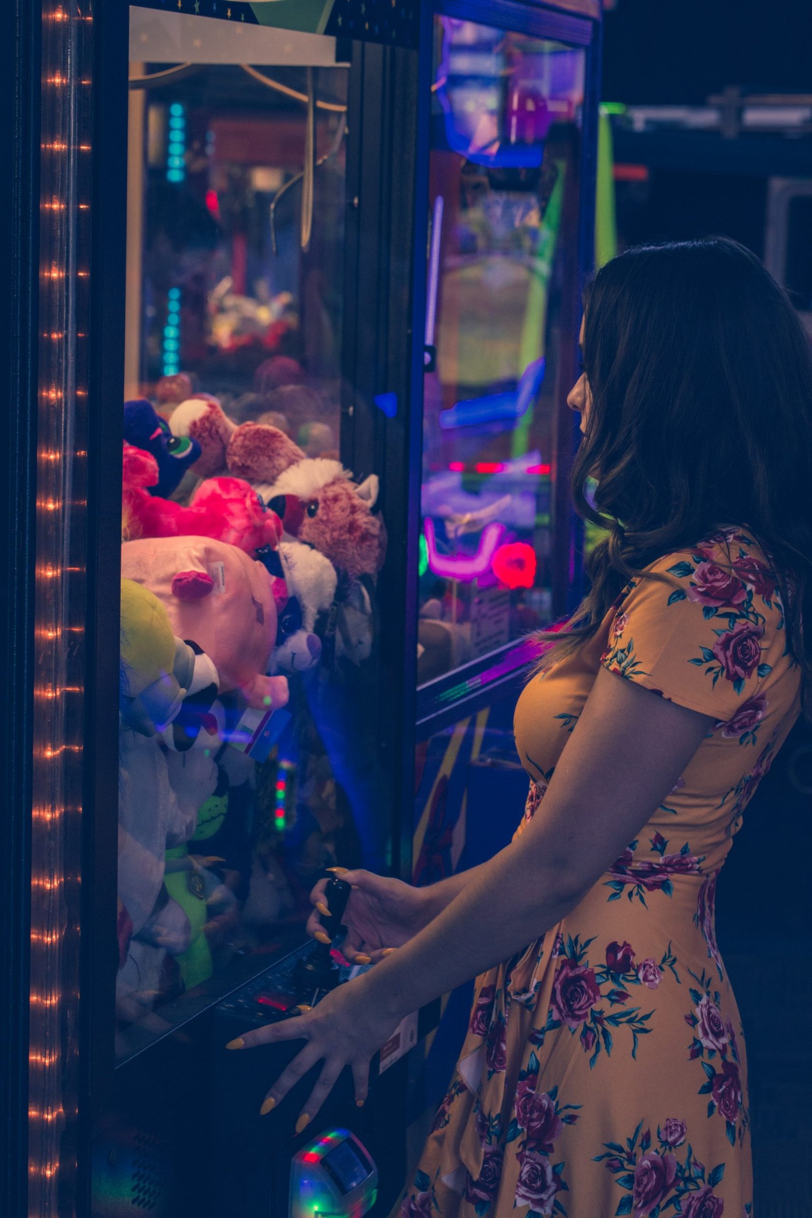 Woman winning claw machine prize