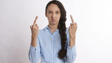woman with two middle fingers raised