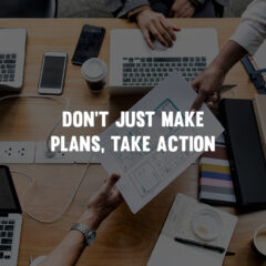 don't just make plans, take action. Business desk with people hading papers to each other.